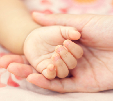 Mom holding babies hand